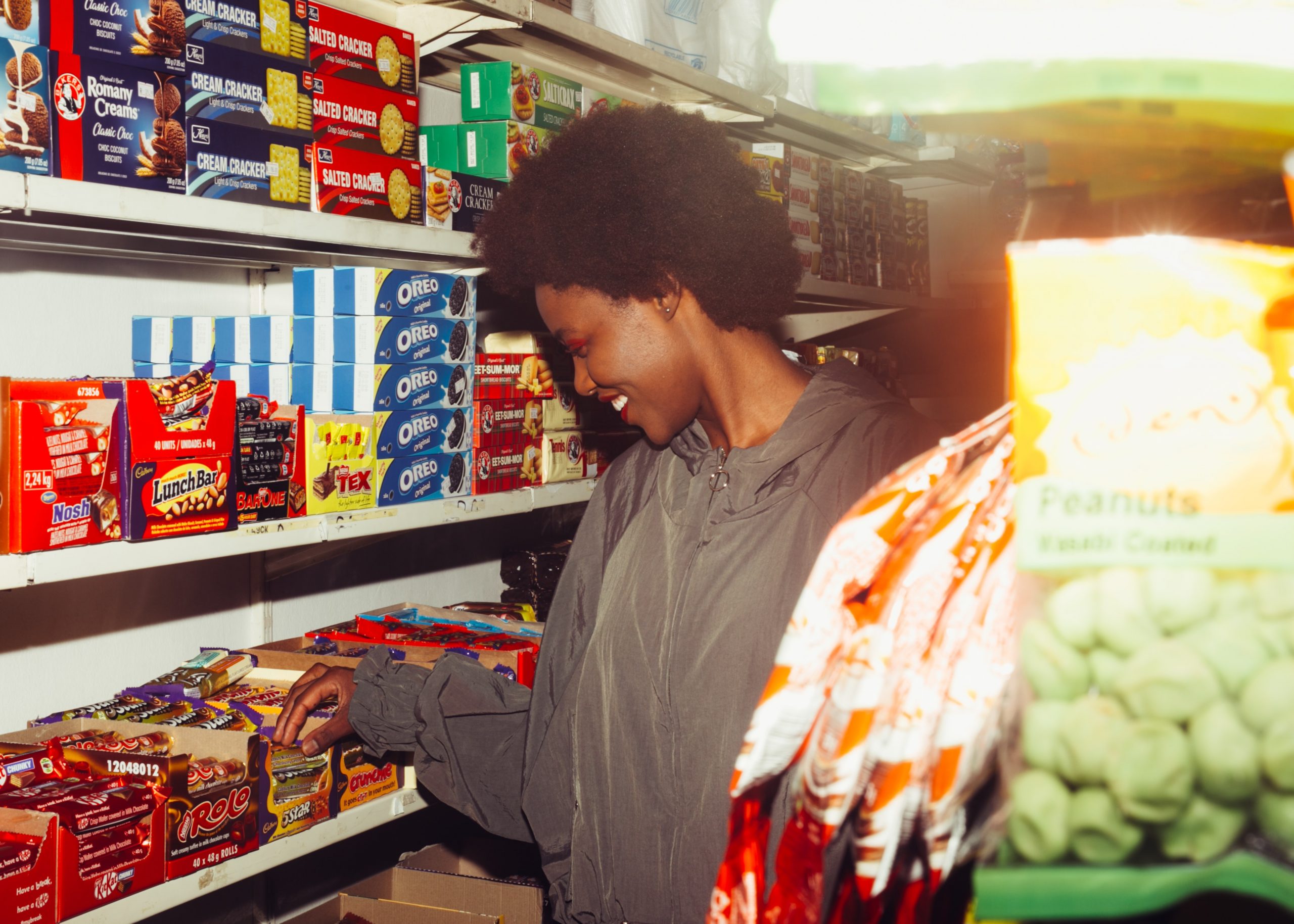 Woman checking British candies in a convenience store